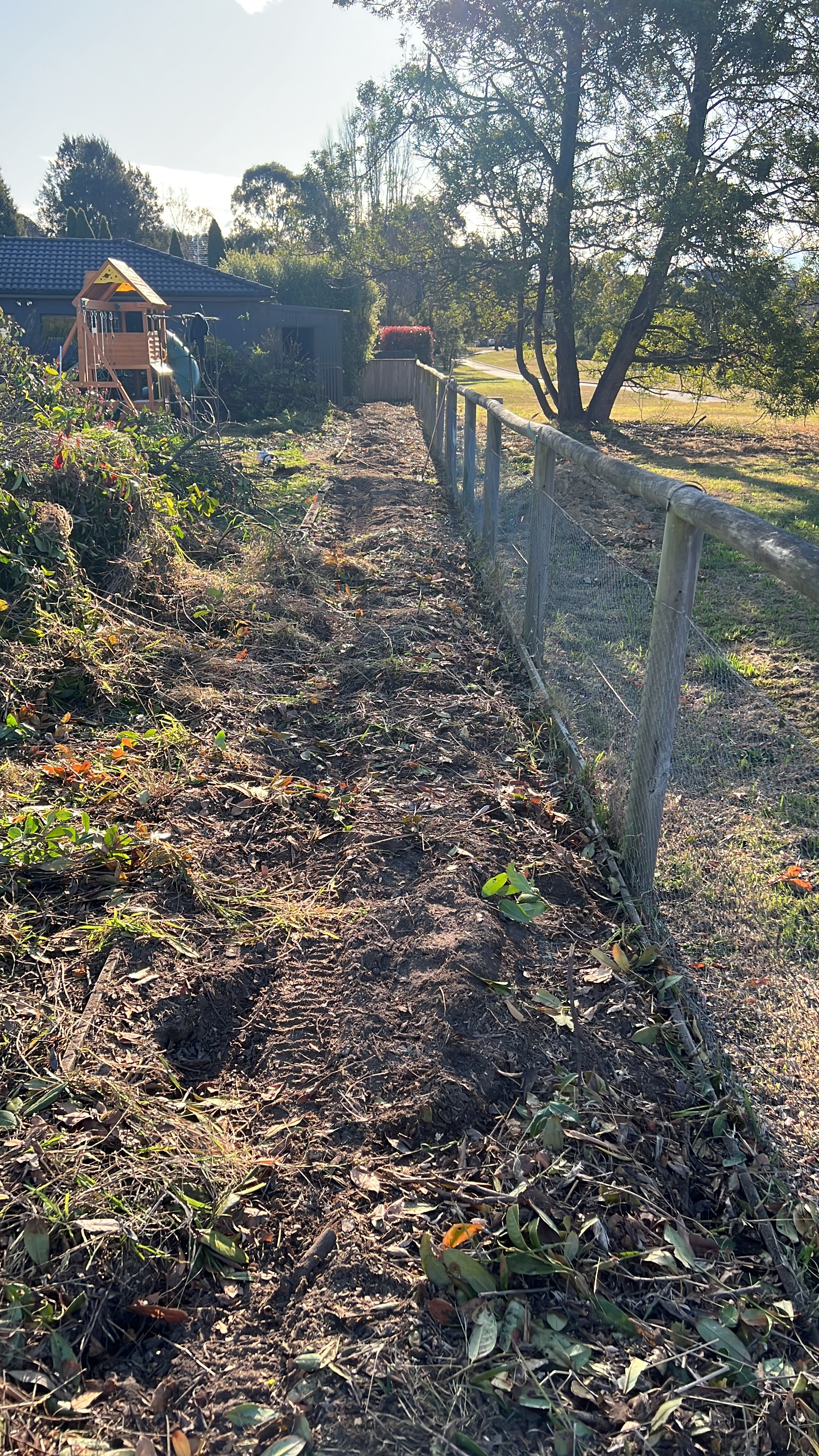 Cleared fence line on a Southern Highlands rural property after stump and debris removal by Southside Stump Grinding